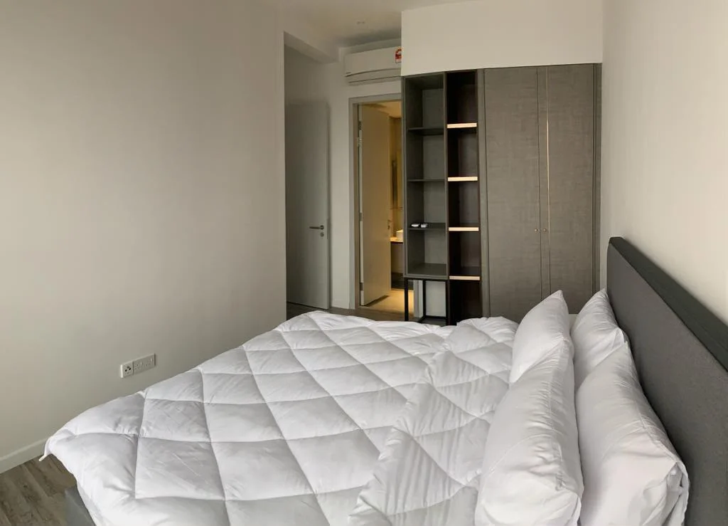 Bedroom features: king-size bed with white bedding, upholstered headboard, built-in wardrobe with grey finish, laminate flooring, white painted walls, recessed ceiling lights, door leading to bathroom, window with no visible treatment; style: modern.
